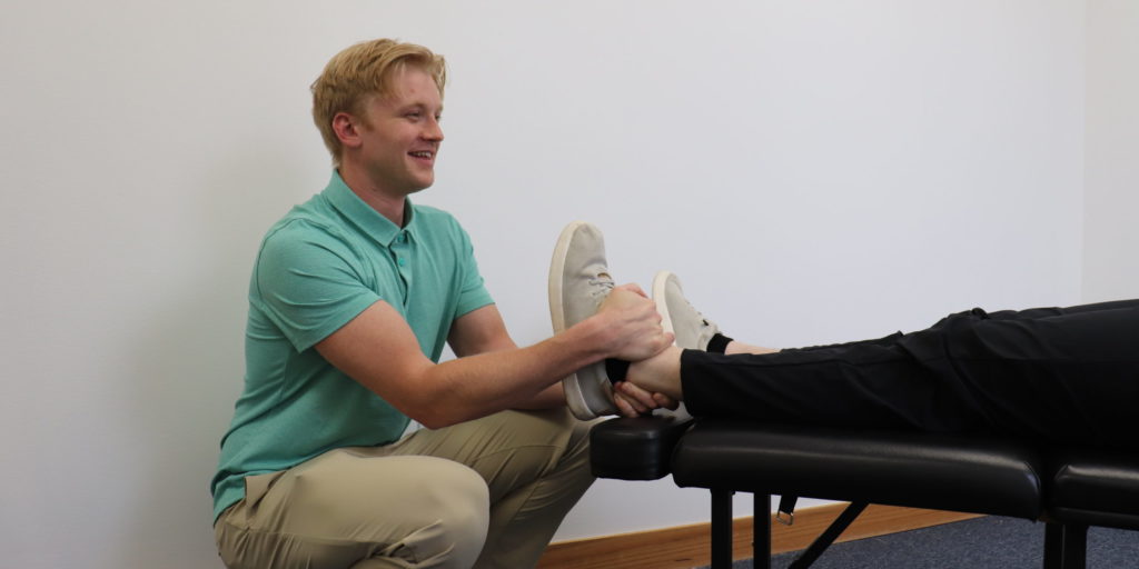 Dr. Cole giving a chiropractic adjustment to the ankle.